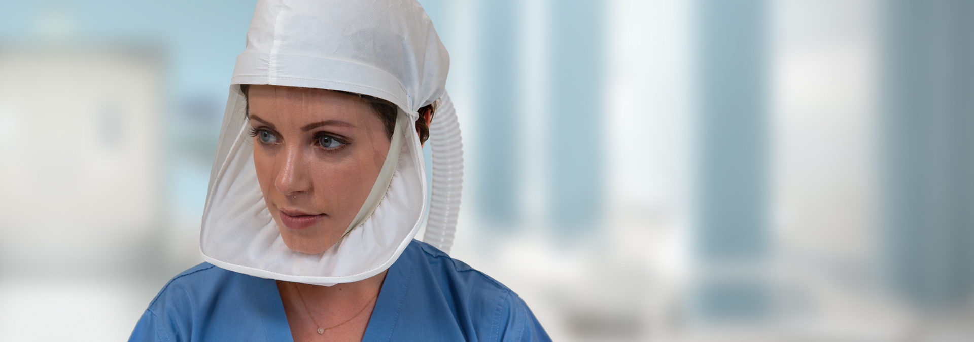 Healthcare professional wears ILC Dover's Sentinel XL®️ HP powered air purifying respirator (PAPR) head cover